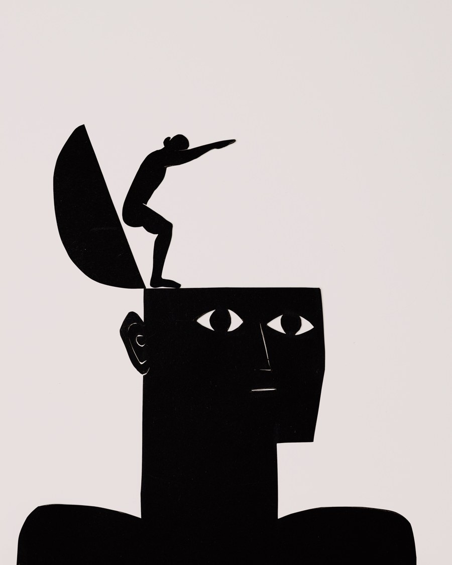 A paper-cut silhouette of a head opening at the top, with a small figure climbing out of it